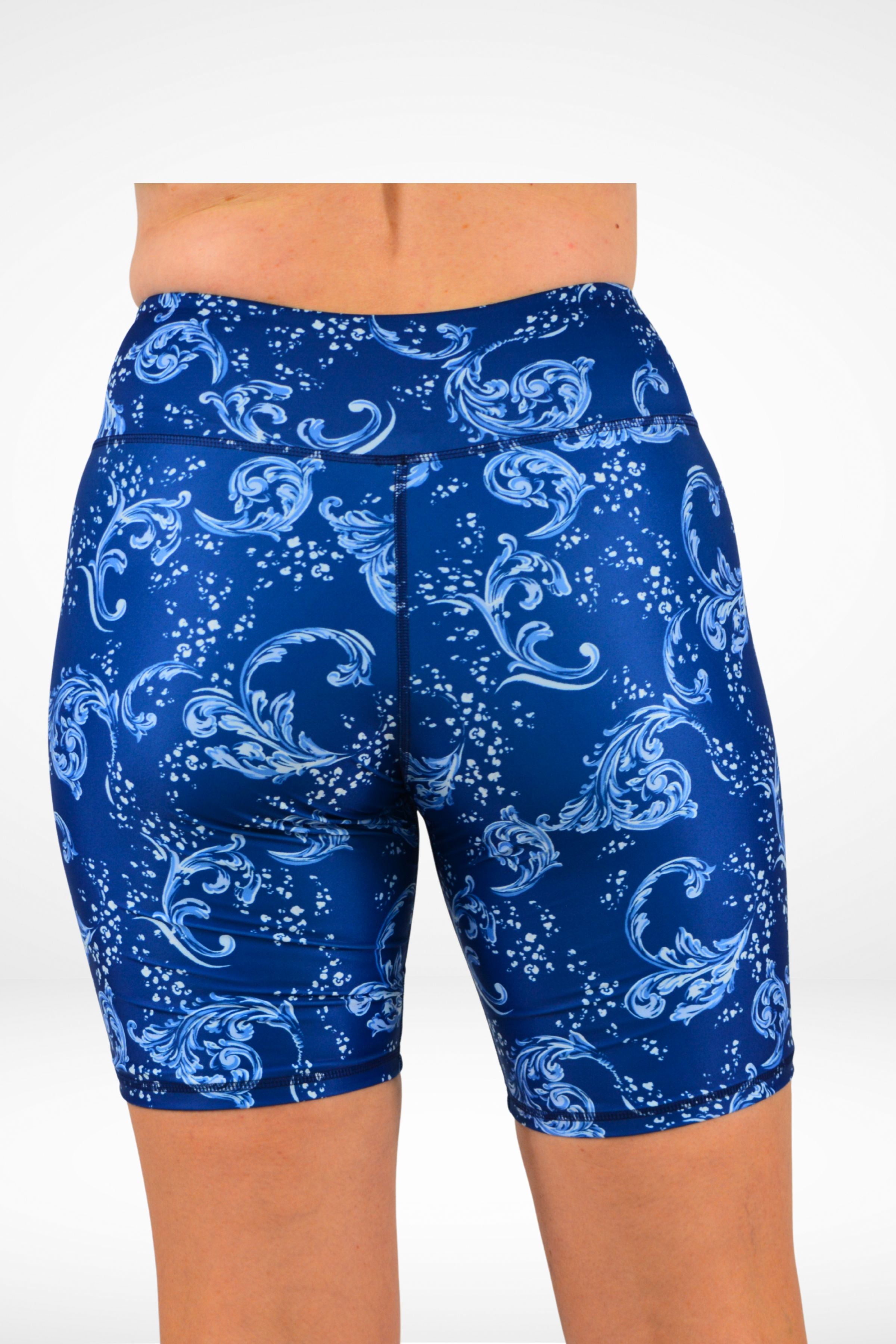 Blue patterned shorts worn by a person on a white background