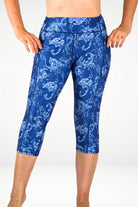 Blue patterned leggings worn by a person on a white background