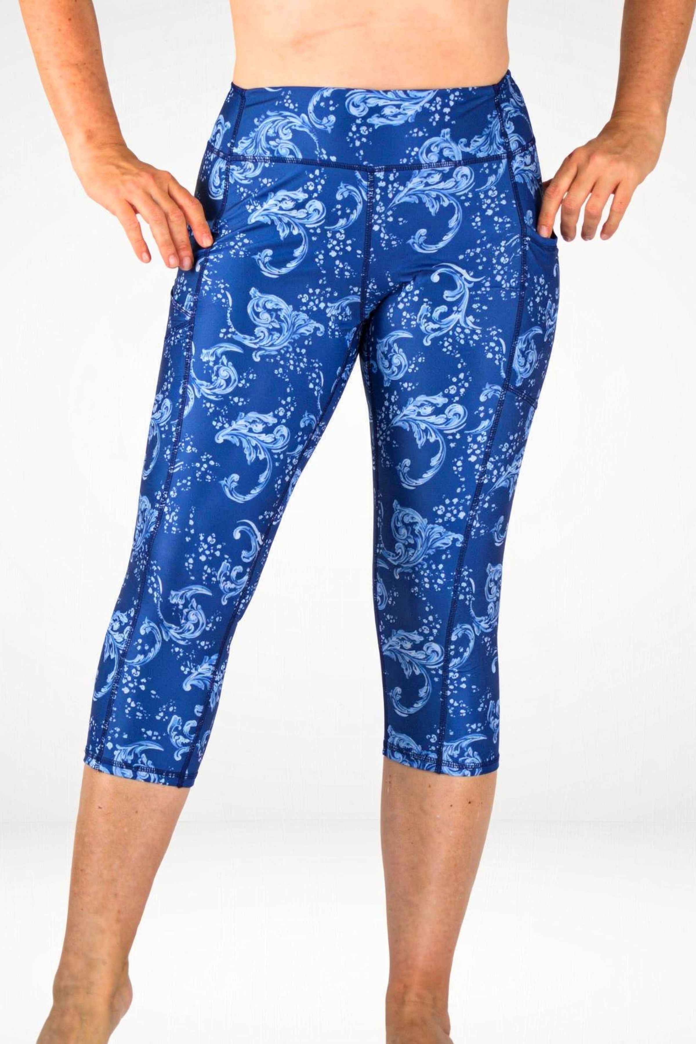 Blue patterned leggings worn by a person on a white background