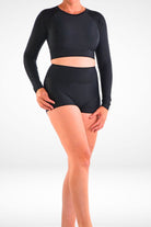 women wearing long sleeve crop rash guard in black and black swim shorties