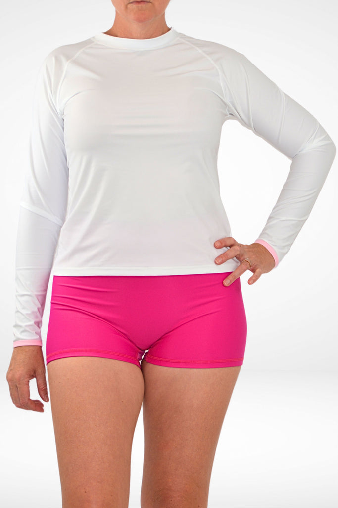 model wearing white andavi swim rash guard and pink swim shorties 